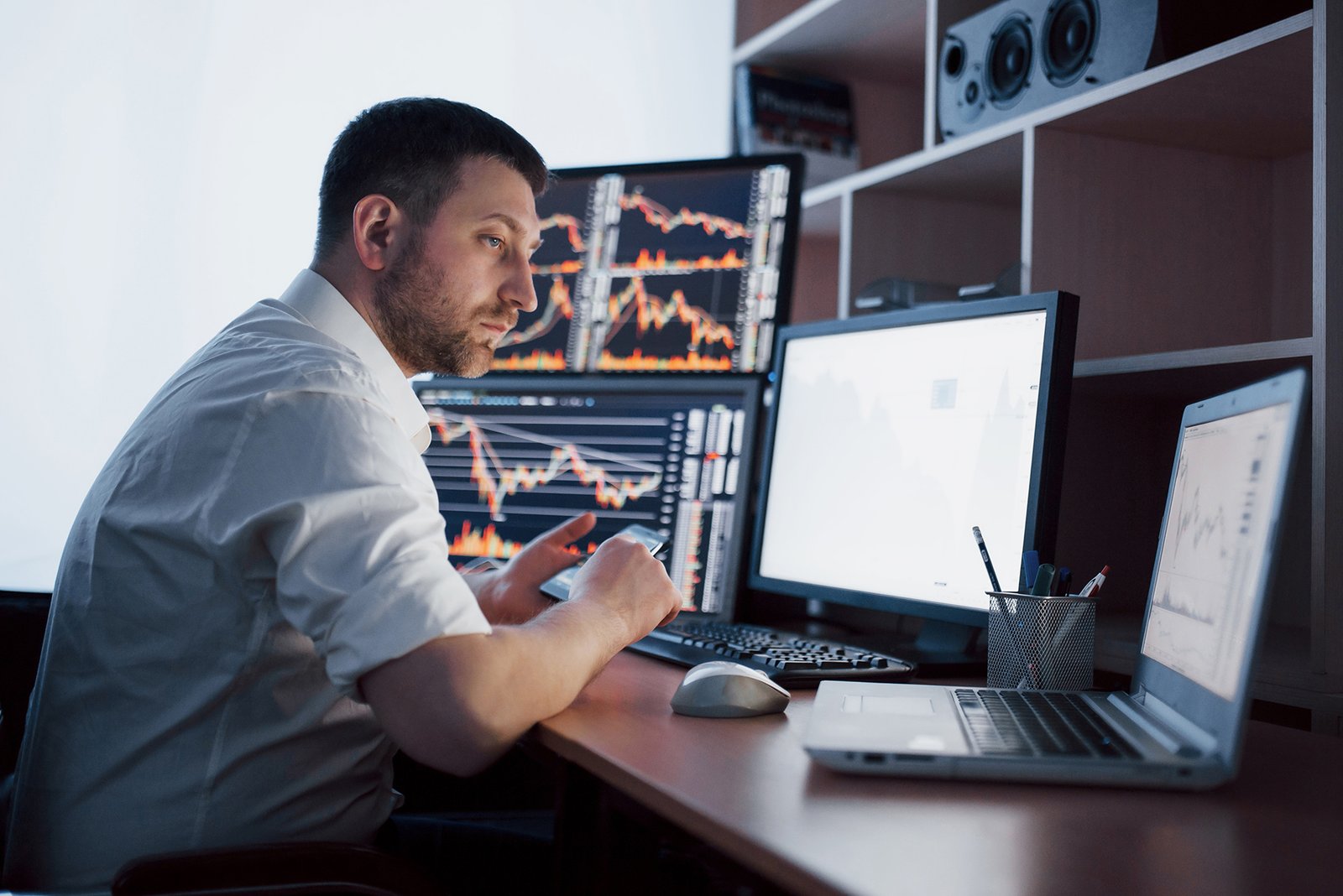 busy working day. close up of young businessman looking at monitor while sitting at the desk in creative office