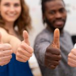 close up people with thumbs up