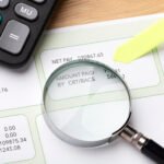 payroll still life with magnifying glass