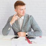 pensive realtor sitting office