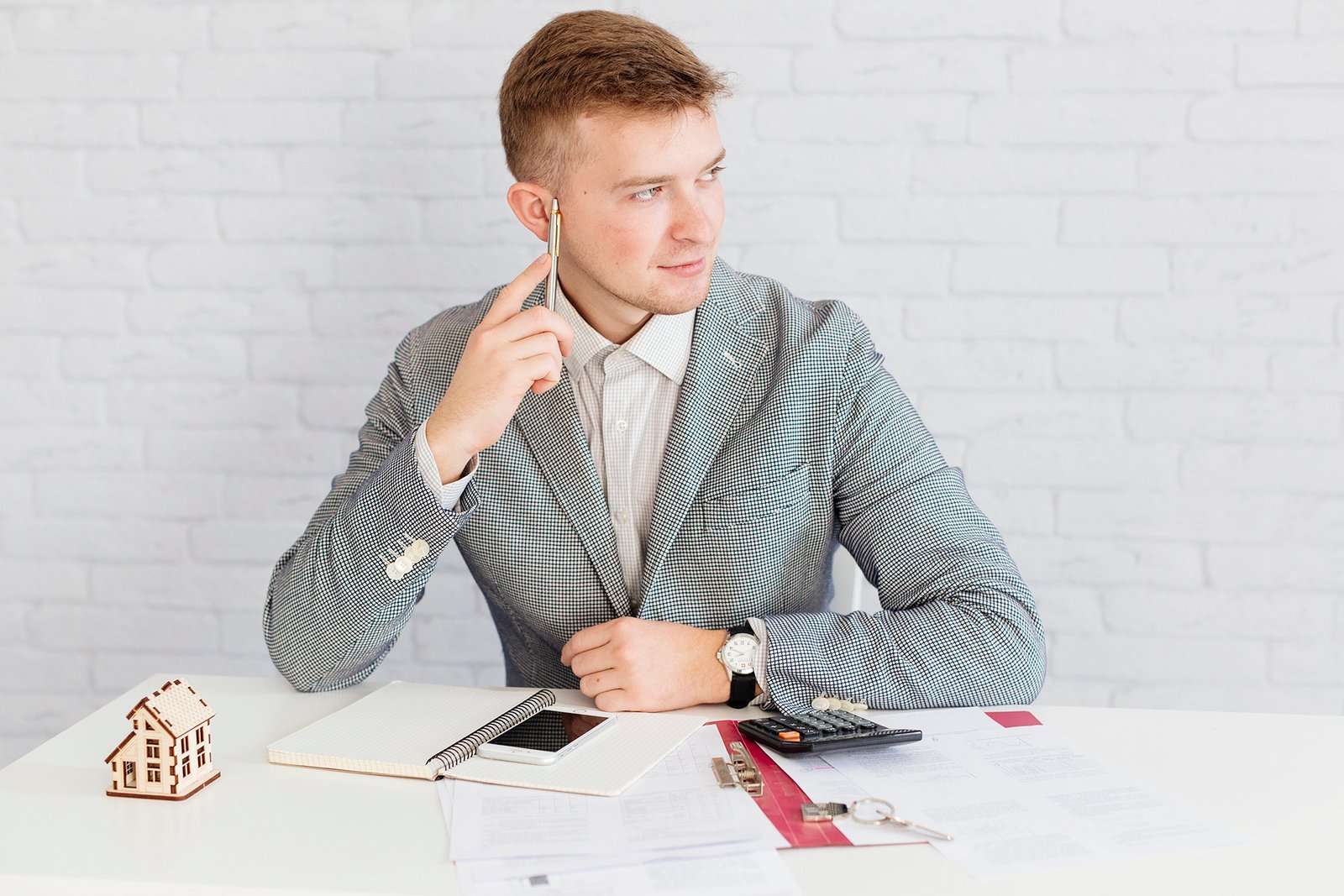 pensive realtor sitting office