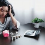 stressed businesswoman working while sitting table