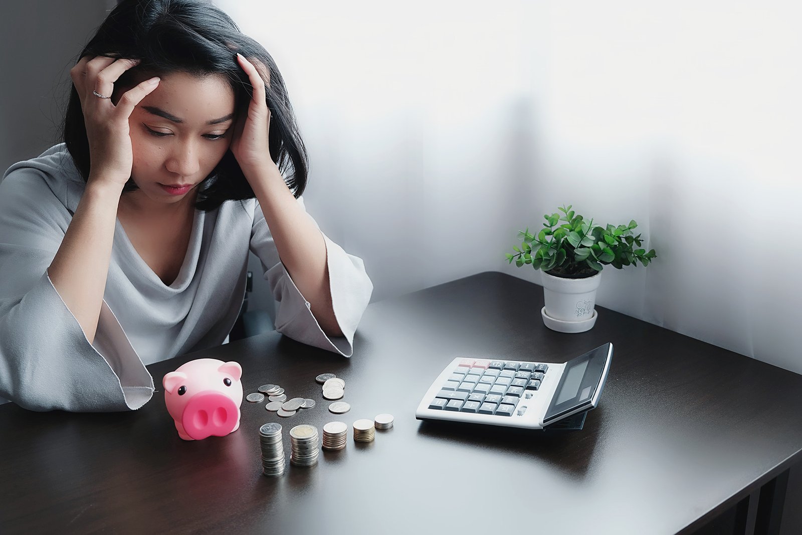 stressed businesswoman working while sitting table